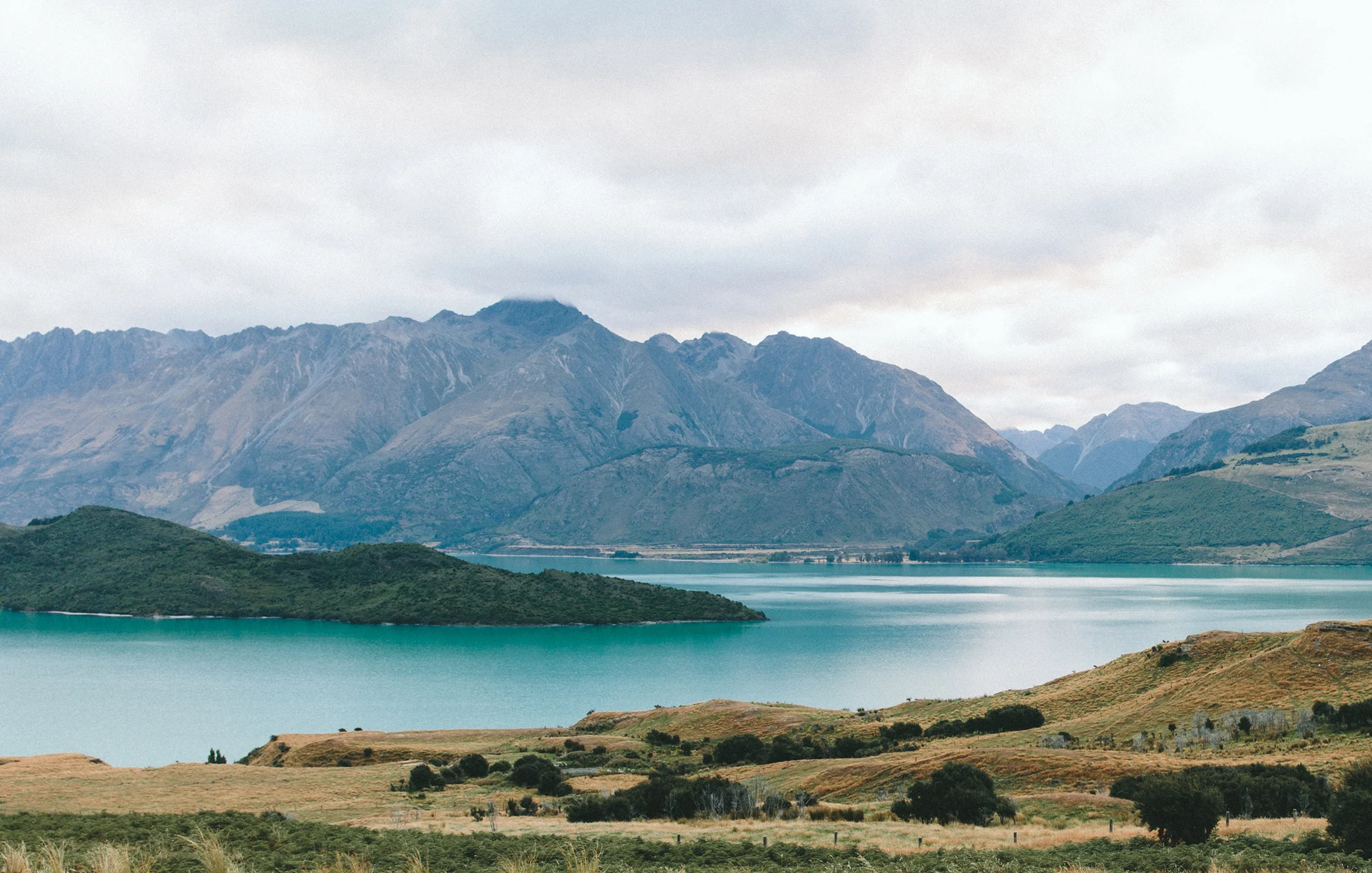 A turquoise alpine lake beneath mountains